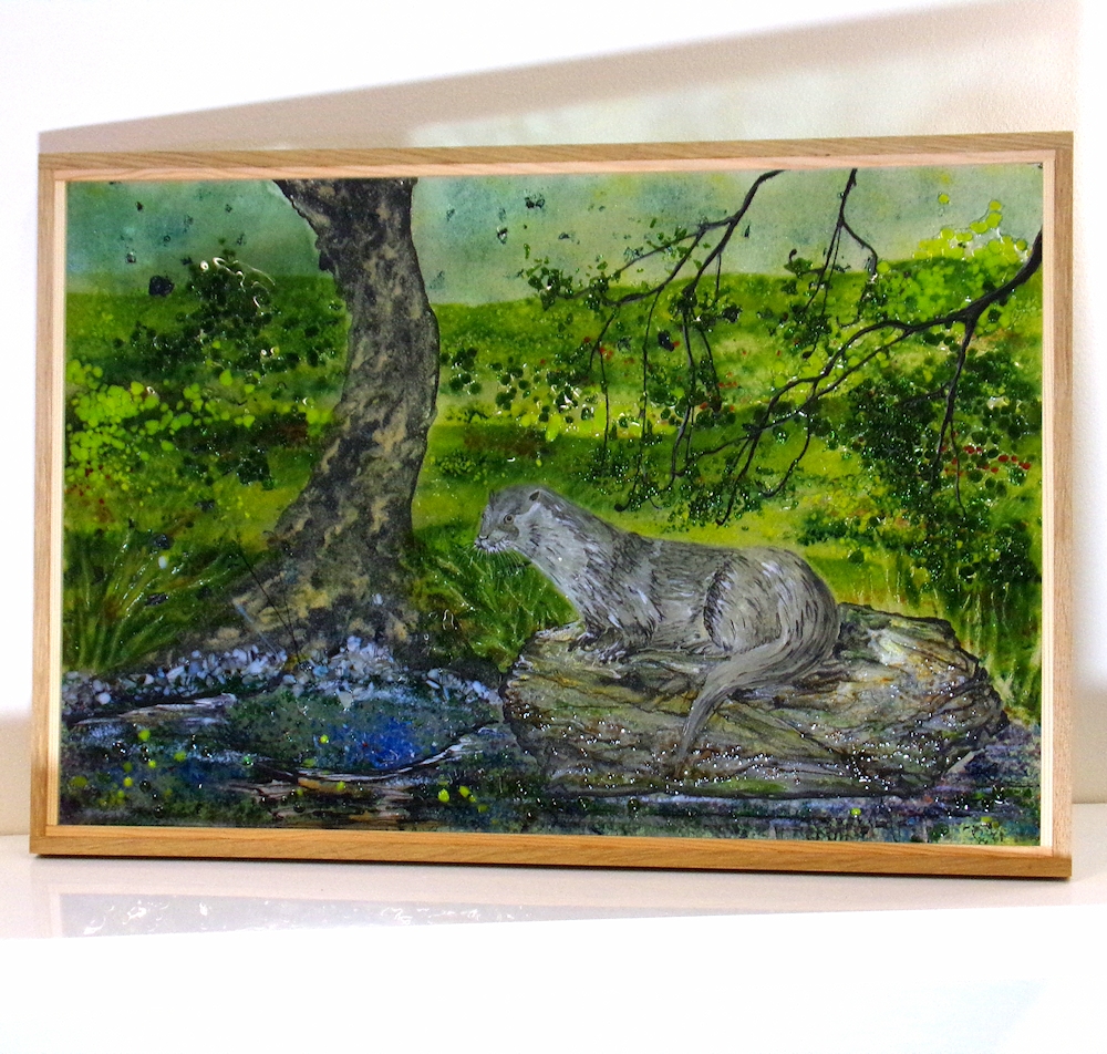 Fused glass picture framed in oak. An otter resting on a rock canal side.