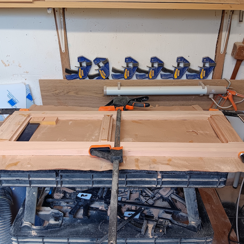 The wooden frames for the door frames clamped whilst the glue is drying