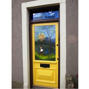 Door panels installed in the customers' home. The white of the swans in prominent against the background of the canal and sky