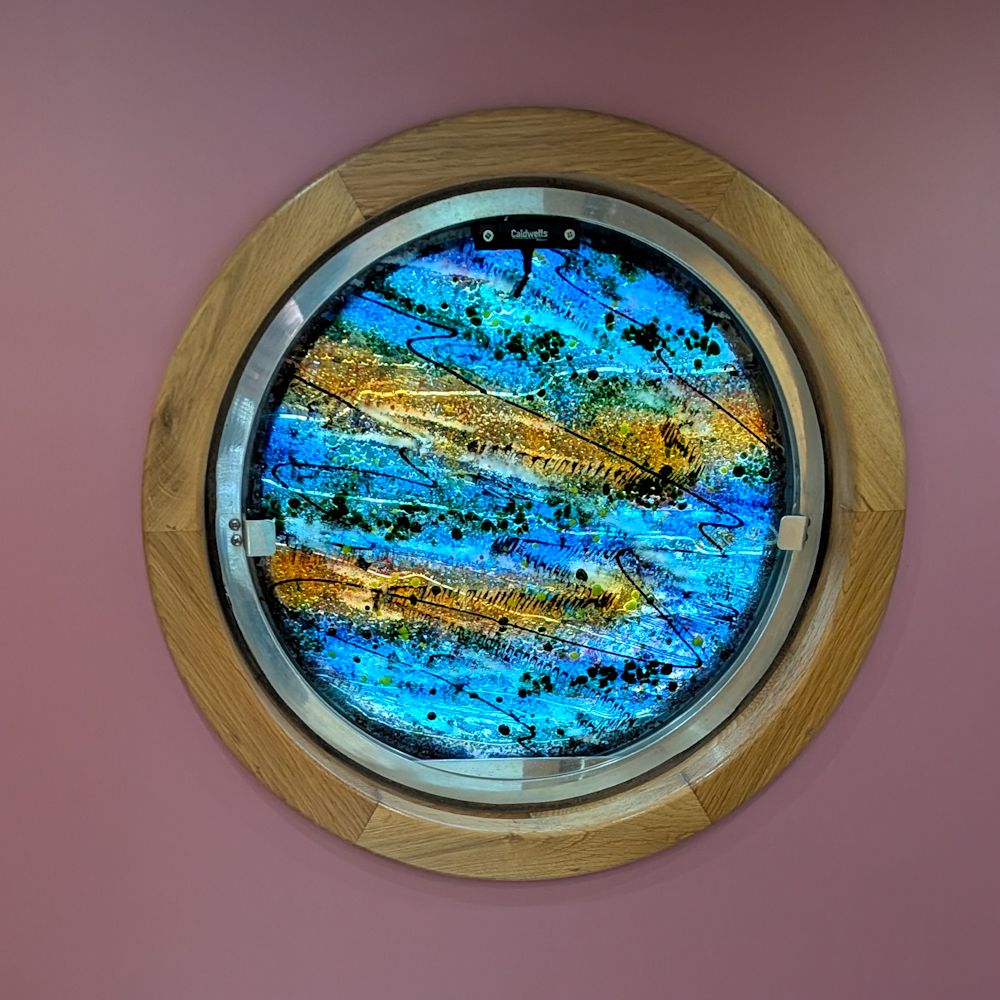 Blue, green and yellow patterns as seen in summer reflecting on water.