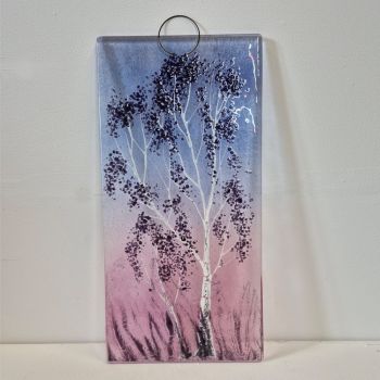A fused glass wall hanging. Dusk is a Silver Birch tree with pink/purple colours