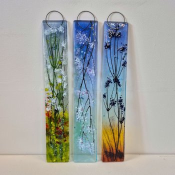 Three medium fused glass wall hangings in different designs featuring blossom. Spring Cow Parsley with white blossom, pink Cherry Blossom and a Twilight scene with seed heads in silhouette.